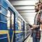 A young couple wait to board a train