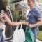 A husband and wife taking the groceries in from the car