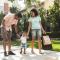Young family walking on sidewalk in residential neighbourhood after a day of downtown shopping